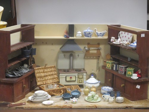 Lot 157 - A dolls kitchen in a scratch built shaped case...