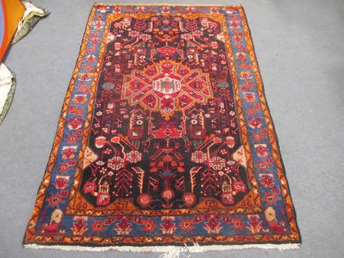 Lot 507 - A modern caucasian rug with stylised motifs on...
