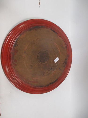 Lot 32 - A large red painted wooden platter, 53cm diameter