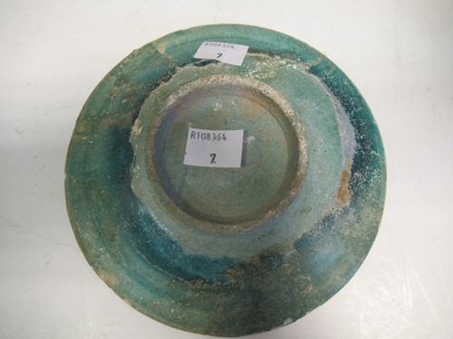 Lot 22 - A Kashan pottery green glazed dish, 15cm diameter