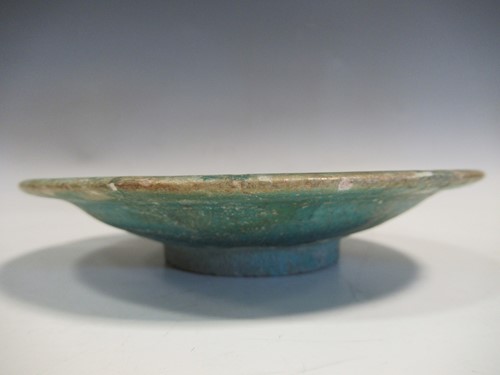 Lot 22 - A Kashan pottery green glazed dish, 15cm diameter