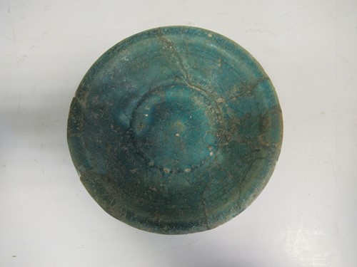 Lot 22 - A Kashan pottery green glazed dish, 15cm diameter