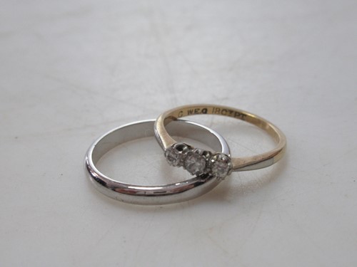 Lot 175 - A three stone diamond ring stamped ' 18CT PT',...