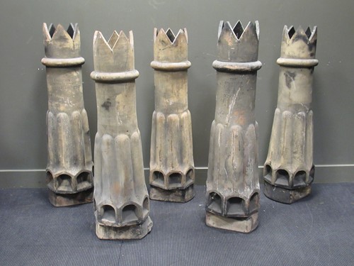 Lot 544 - A set of five terracotta Champion chimney pots,...