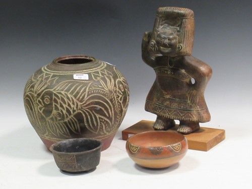 Lot 12 - A terracotta vase of squat globular form...