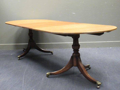 Lot 624 - A reproduction mahogany extending dining table,...
