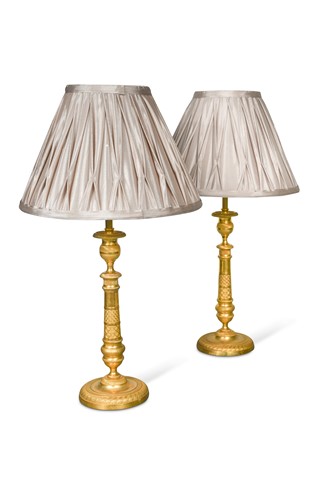 Lot 815 - A pair of Regency engine turned ormolu candlestick lamps, circa 1820