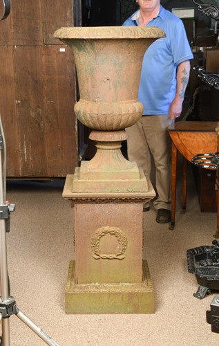Lot 973 - Two cast iron garden urns of similar design, early 20th century