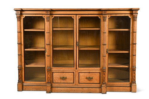 Lot 932 - A mid Victorian oak and ebonised breakfront bookcase