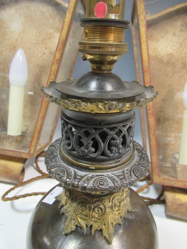 Lot 37 - A pair of patinated and gilt wall lights...