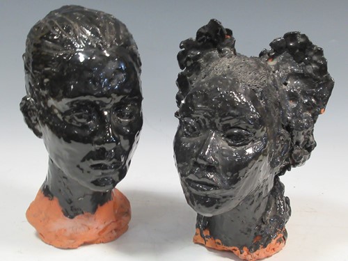 Lot 107 - A pair of black glazed clay sculptures busts...