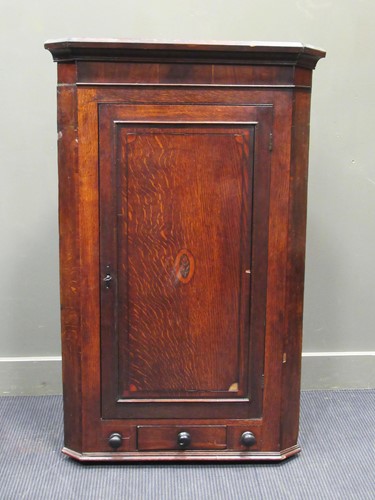 Lot 692 - A Georgian oak and mahogany corner cupboard...