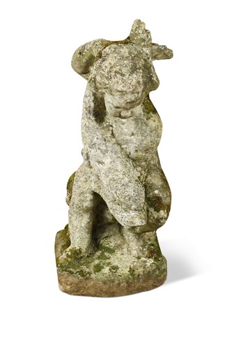 Lot 662 - A composite stone figure of a putto with fish, early 20th century