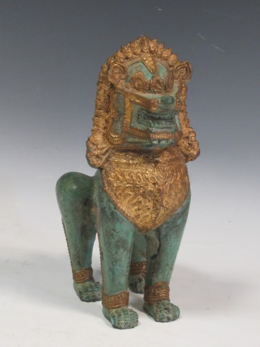 Lot 47 - A South East Asian parcel-gilt temple dog,...