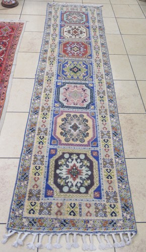 Lot 731 - A modern pale ground runner decorated with...
