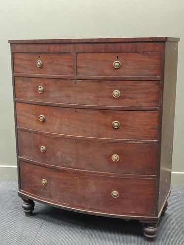 Lot 704 - An early 19th century tall mahogany bow front...