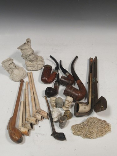 Lot 105 - A large collection of clay and wooden...
