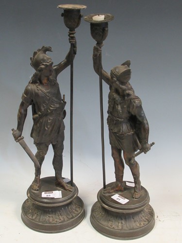 Lot 85 - A pair of spelter candlesticks modllled as...