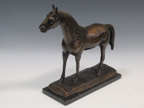 Lot 106 - A bronze model of a horse raised on a marble...