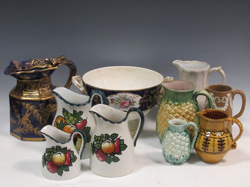Lot 126 - A collection of various ceramic jugs to...