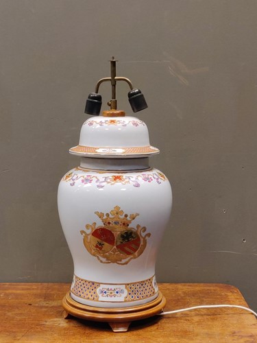 Lot 164 - A large baluster lamp enamelled with a crest