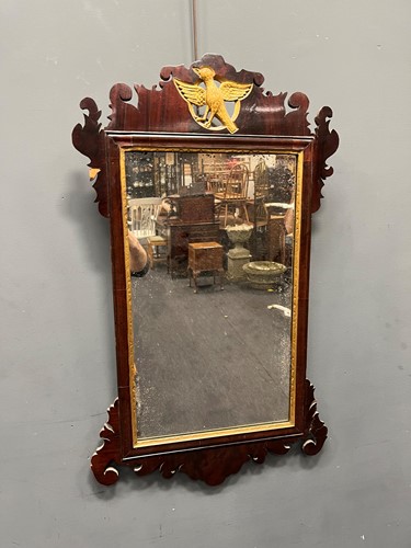 Lot 558 - A fret carved mahogany mirror surmounted by a...