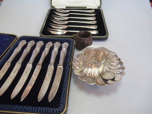 Lot 282 - A collection of silverware including a shell...