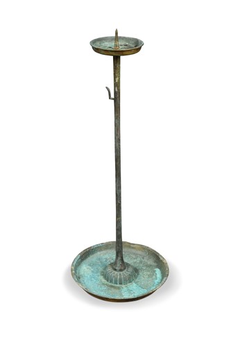 Lot 606 - A patinated brass pricket candlestick