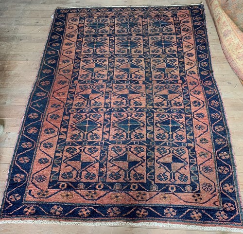 Lot 512 - A Belouch wool tribal rug with madder field...