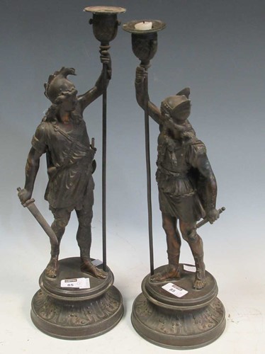 Lot 35 - A pair of spelter candlesticks modelled as...