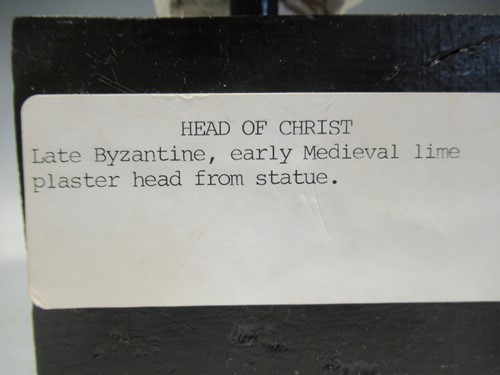Lot 31 - A plaster model of Christ's head on a black...