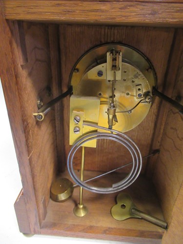 Lot 19 - An early 20th oak cased mantle clock retailed...