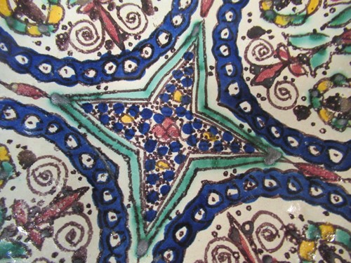 Lot 36 - Three Moroccan plates, each decorated with...
