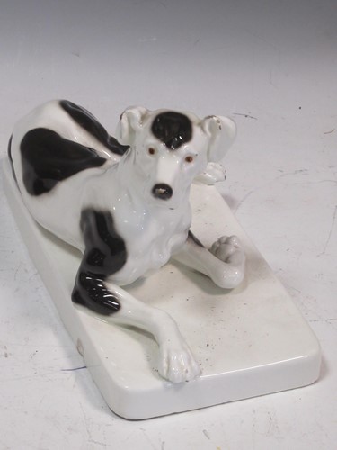 Lot 46 - A Goldscheider figure of a reclining dog, 14.5...