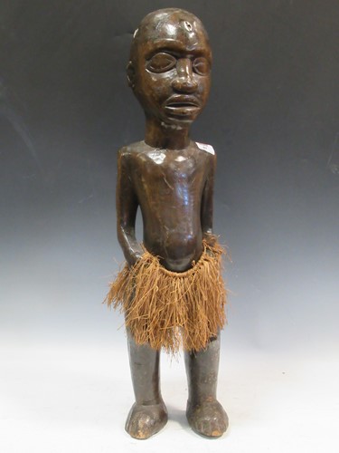 Lot 87 - A carved wood tribal figure of a man 74cm high