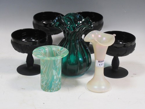 Lot 177 - A set of four pressed matte black wine goblets...