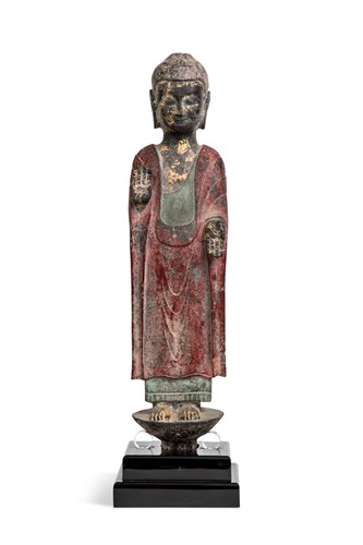 Lot 86 - A Chinese painted and parcel gilt grey stone standing figure of Buddha, in Northern Wei style