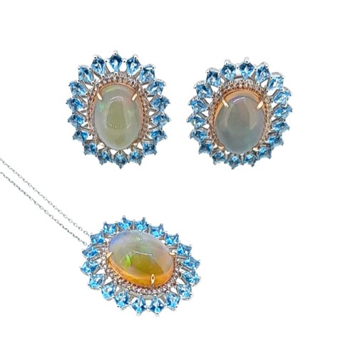 Lot 256 - An opal and topaz pendant with matching ear studs