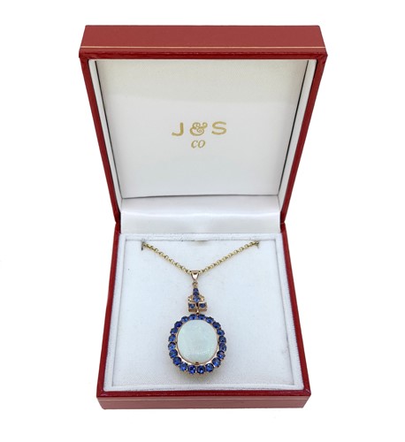 Lot 33 - An opal and sapphire cluster pendant and chain