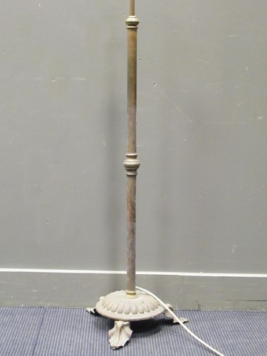 Lot 410 - A 20th century brass standard lamp raised on...