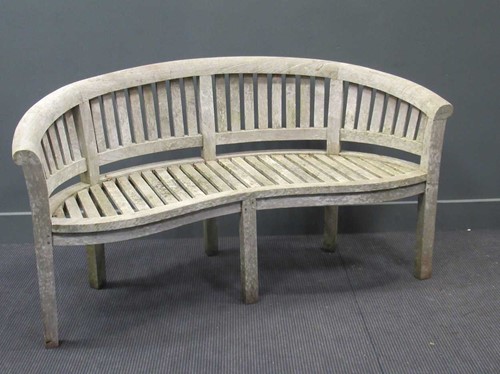 Lot 408 - A 20th century teak garden bench with curved...