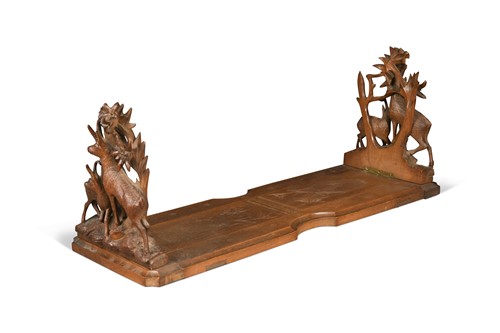 Lot 704 - A Black Forest carved wood book slide, early 20th century
