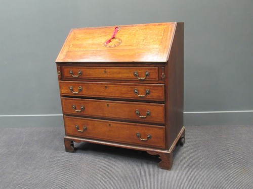 Lot 450 - A George III inlaid oak bureau, the fall front...