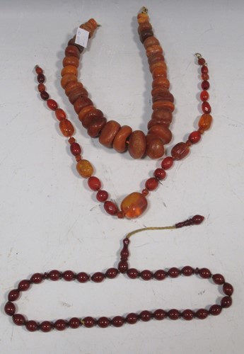 Lot 165 - Two amber necklaces, together with a cherry...