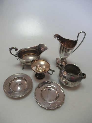 Lot 179 - A silver helmet shaped cream jug together with...
