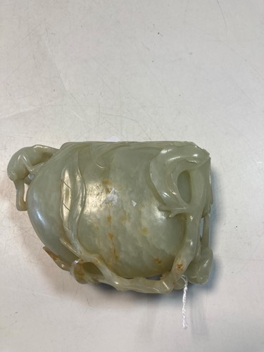 Lot 70 - A Chinese mutton fat jade ape and fruit bowl,  Qing Dynasty, 19th century