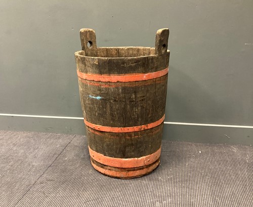 Lot 407 - A coopered oak barrel 88cm high and 60cm wide