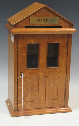 Lot 87 - An oak letter box modelled as a door front...