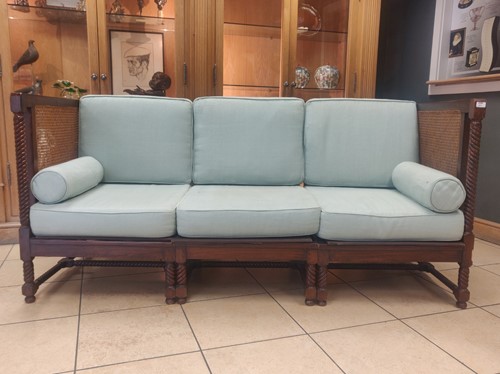 Lot 411 - A blue upholstered caned three-seater settee...