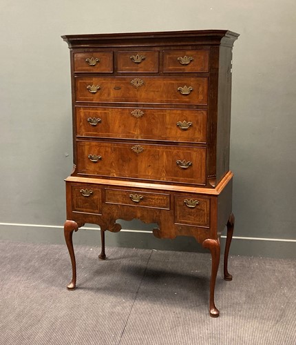 Lot 377 - An 18th century walnut chest on stand raised...